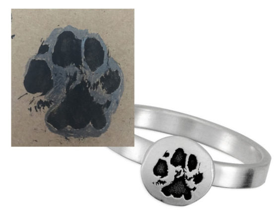 A sterling silver ring, etched with the actual paw print shown in the picture